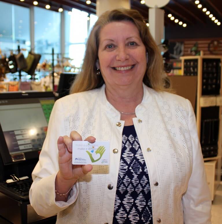 Anne Collins holds up the new OnTheGo gift card offered by HHSVA.