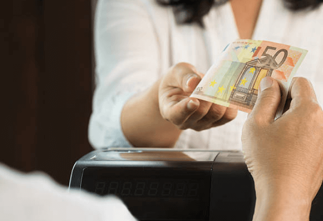 cashier holding a cash register